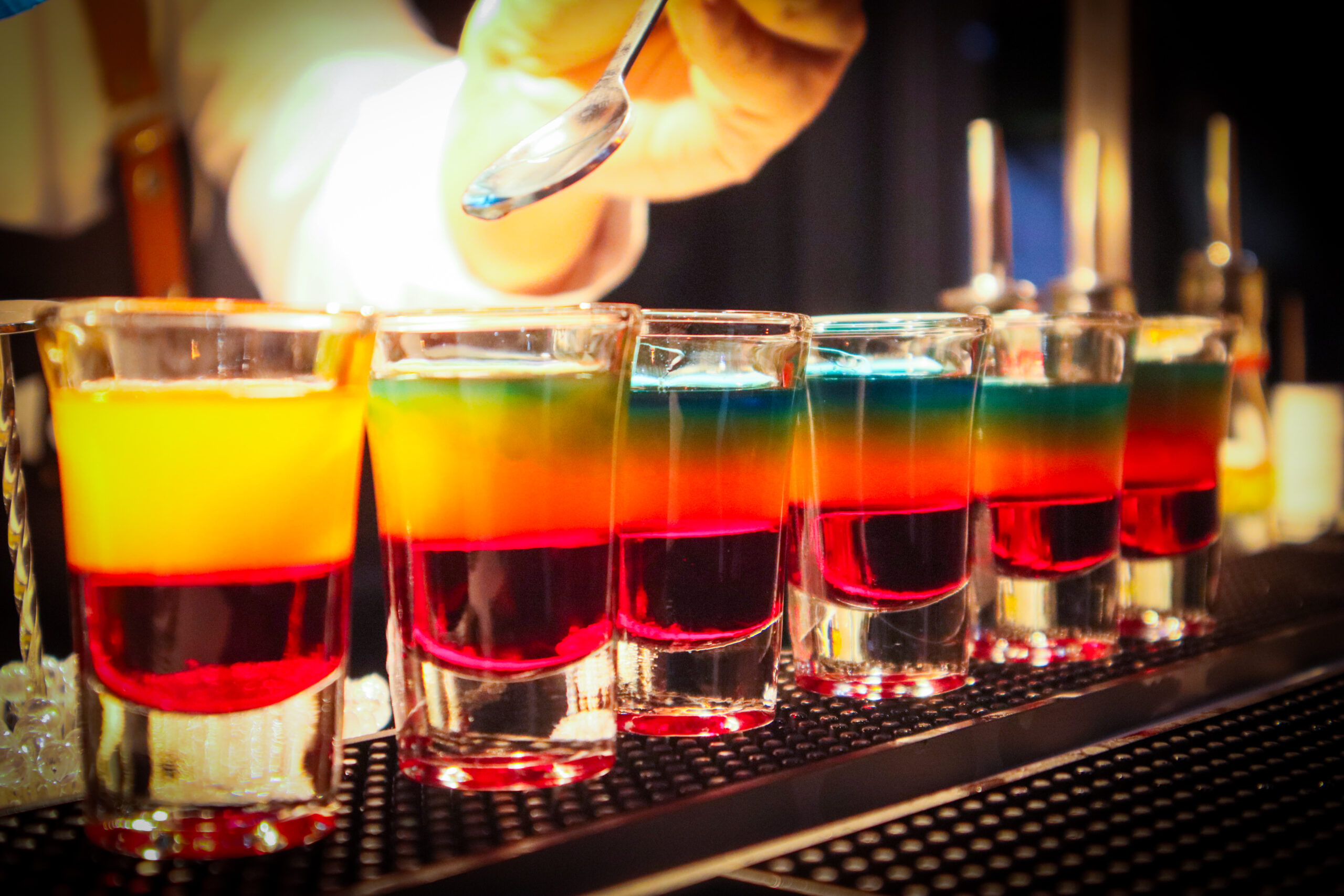 Ignite Shots - layered rainbow shot glasses being finished tableside at an Inomoto Mobile Bar event